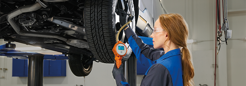 A Subaru technician checking tire pressure. | Stevens Creek Subaru in Santa Clara CA