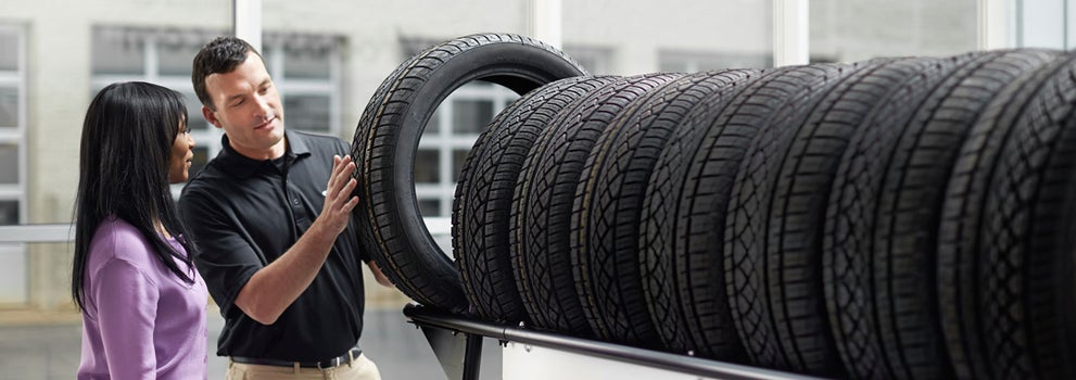 Subaru service representative showing customer a tire. | Stevens Creek Subaru in Santa Clara CA