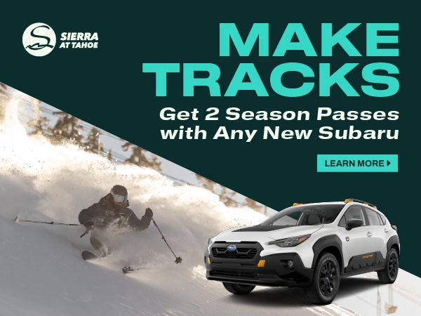 New Solterra EV shown in Cosmic White Pearl in front of a person snowboarding.